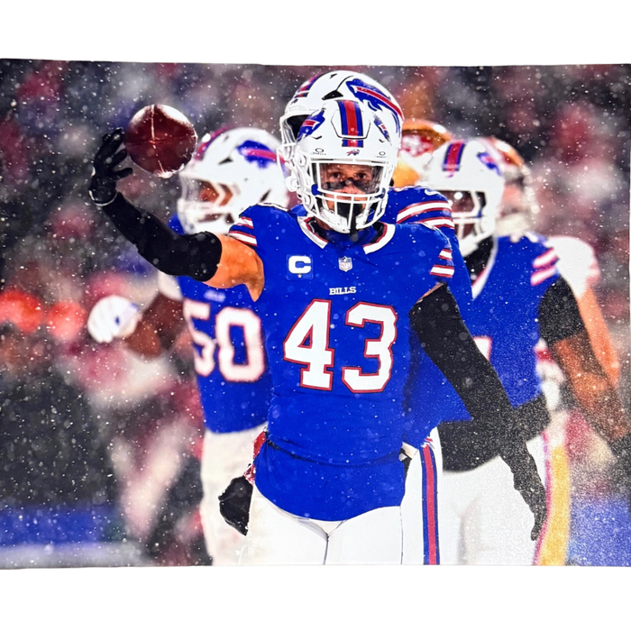 Terrel Bernard Unsigned Holding Football in Snow 8x10 Photo
